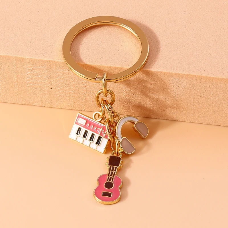 Schlüsselanhänger Gitarre und Musikinstrumente aus Metall in Rosa