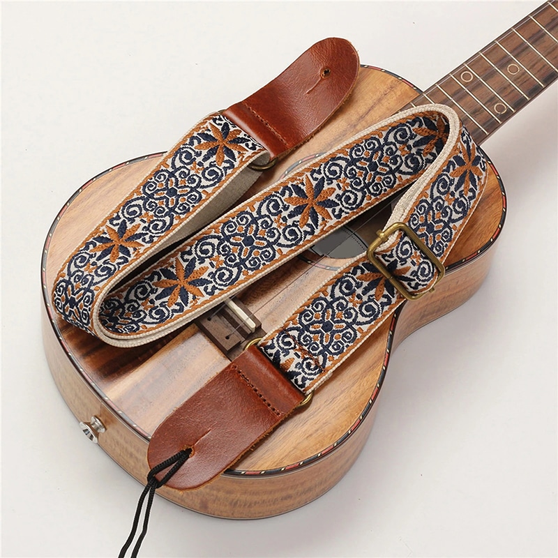 Übersichtsbild von einem Ukulele-Gurt im Vintage-Stil mit blauen und ockerfarbenen, bohemischen Blumen